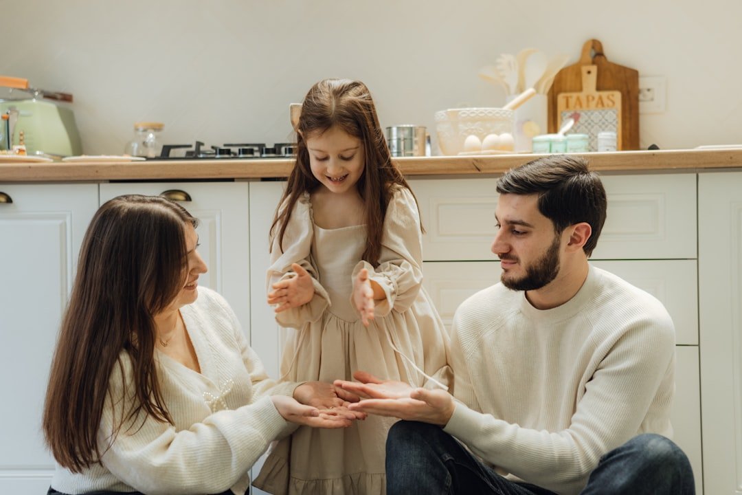a-group-of-people-sitting-around-in-a-kitchen-bkhazen0hg